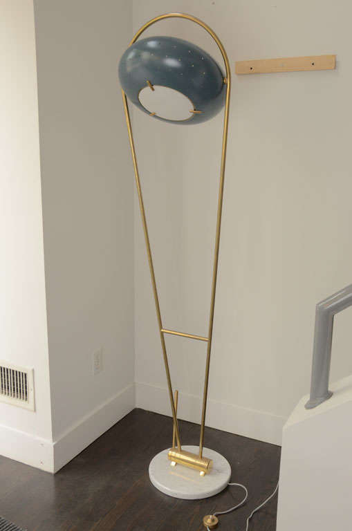 An Italian Floor Lamp by Angelo Lelli for Arredoluce.
A Swivel Red Round Shade and an Adjustable Brass Arm, Standing on a round marble base. Marked
Marked  AL