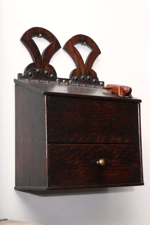 Lovely 18th Century Welsh oak hanging candle box with double open fish tail brackets, over leather hinged slanted flap, the case with beaded edge and with single drawer, the front crafted from single plank of highly figured timber, the whole with