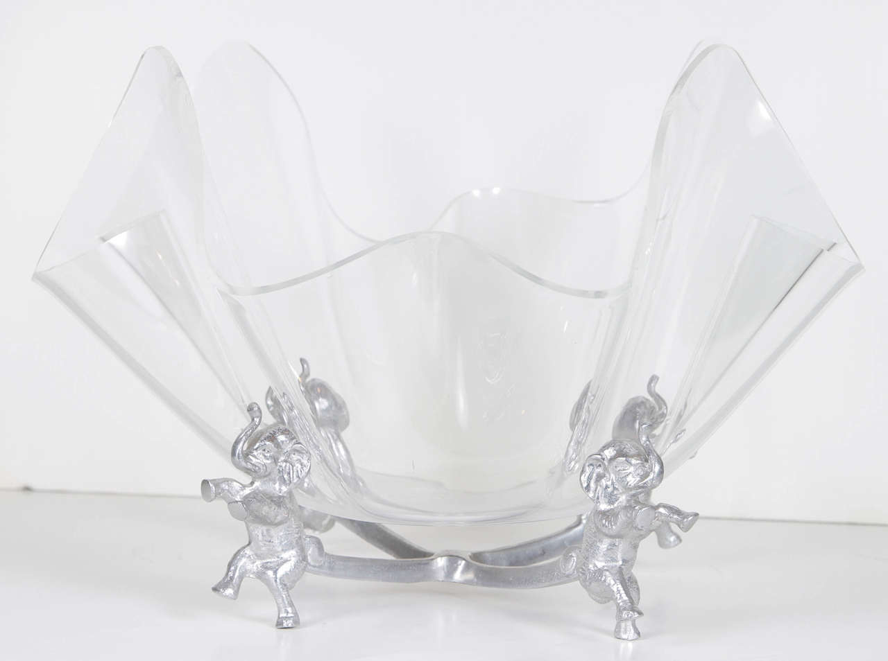 Handkerchief style acrylic bowl on silvered stand with elephants holding the bowl.