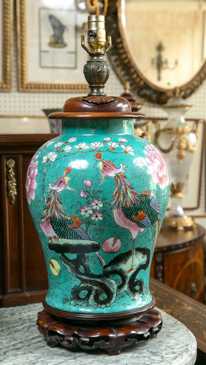 This beautiful pair, in a deep robin's egg  blue palette have hand carved pierced wooden caps and bases. They are hand decorated with phoenix  birds,  peonies and other flowers. The blue background is covered in fine line black lines of branches,
