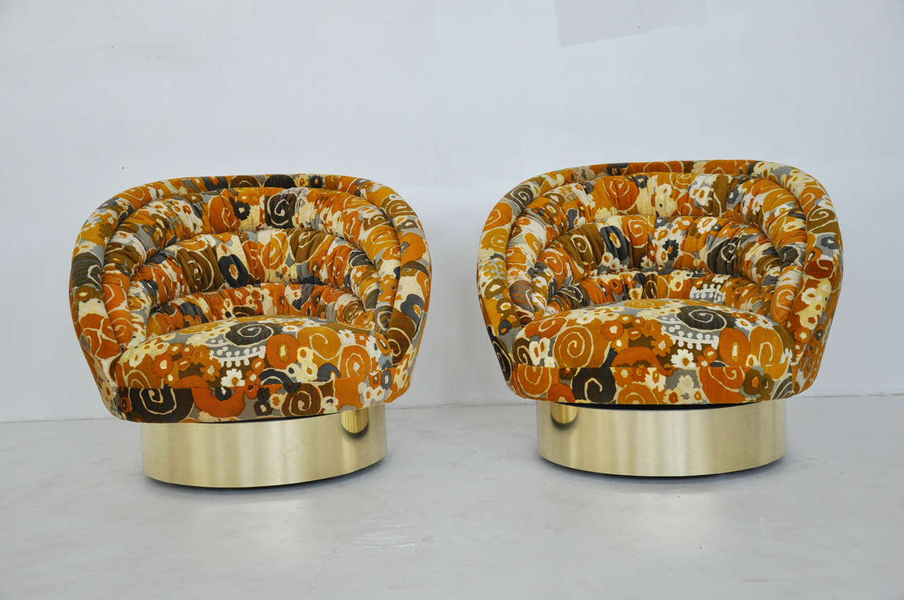 Large-scale swivel chairs by Vladimir Kagan. Brass bases with Jack Lenor Larsen velvet upholstery. Castors are recessed behind brass bases for ease in mobility.