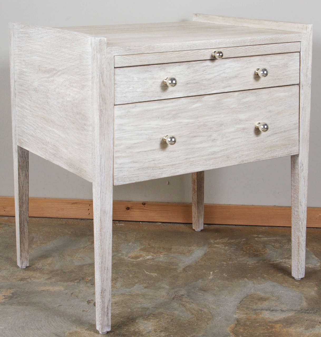 Pair of two-drawer distressed side tables or nightstands with pull-out tray and silver plated knobs.