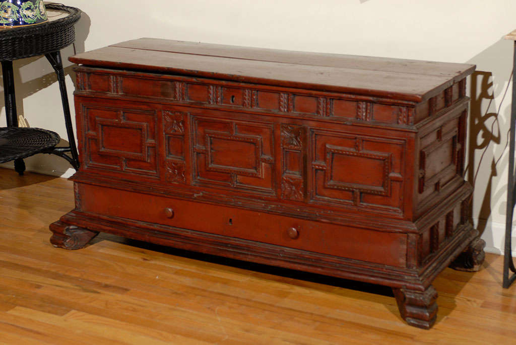 This is a very detailed Spanish Coffer.  The coffer is painted red.  There is a drawer at the bottom which is unusual.  Coffers are also known as trunks but coffers are believed to have preceded trunks.  Coffers were used to store many things from