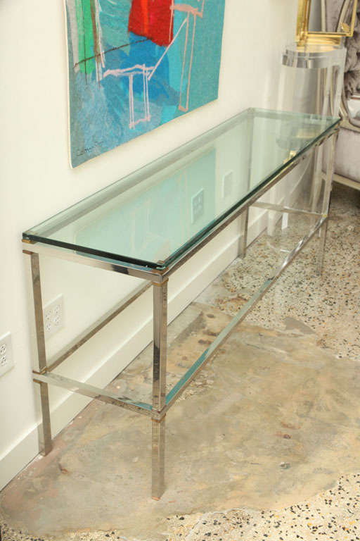 Tres chic, this extra long and heavy steel and brass console with a thick glass top, is Superb. Heavy, measure: 3/4 inch glass top.