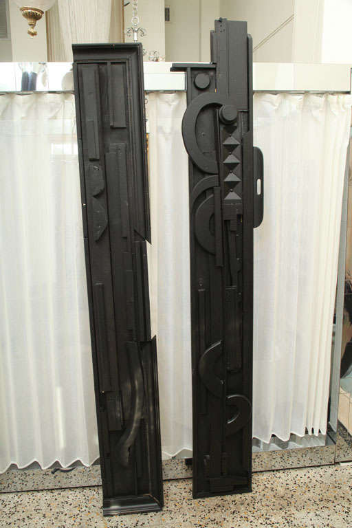 Standing almost 8 feet tall, these two totem sculptures are made of found wooden objects.  Very unique, mixed wood, in a dark, flat black.  In the manner of Nevelson.