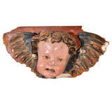 Carved wood putti head