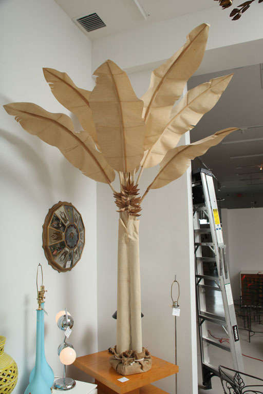 Vintage canvas banana tree with carved wooden bananas cascading down in a bunch.