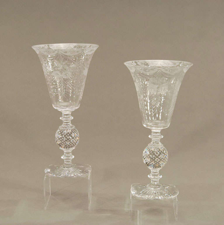 A lovely pair of beatifully matched hand blown crystal trumpet vases with all-over copper wheel engraved floral decoration. The detailed images reveal the contrast between the stone cutting which has a frosted look and the polished cutting wihich is
