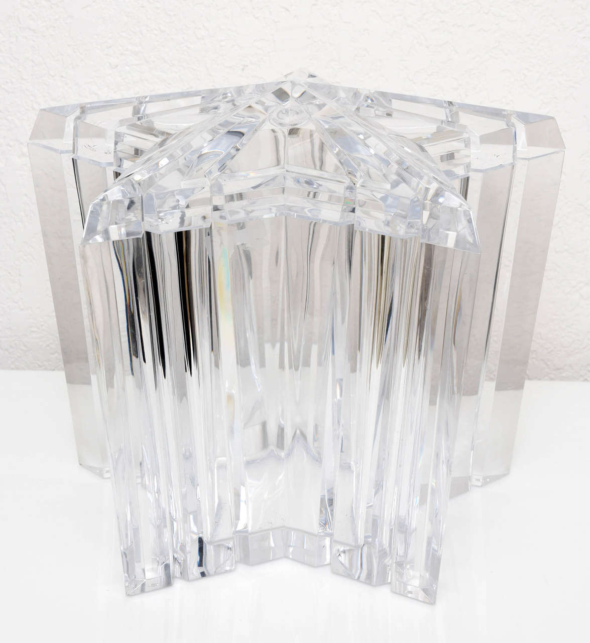 This is the ultimate glamorous and sophisticated ice bucket for your stylish "cocktail hour" created in the 1970s. The piece is fabricated in clear, polished Lucite with a faceted/cut detail to it and the lid pivots for ease of