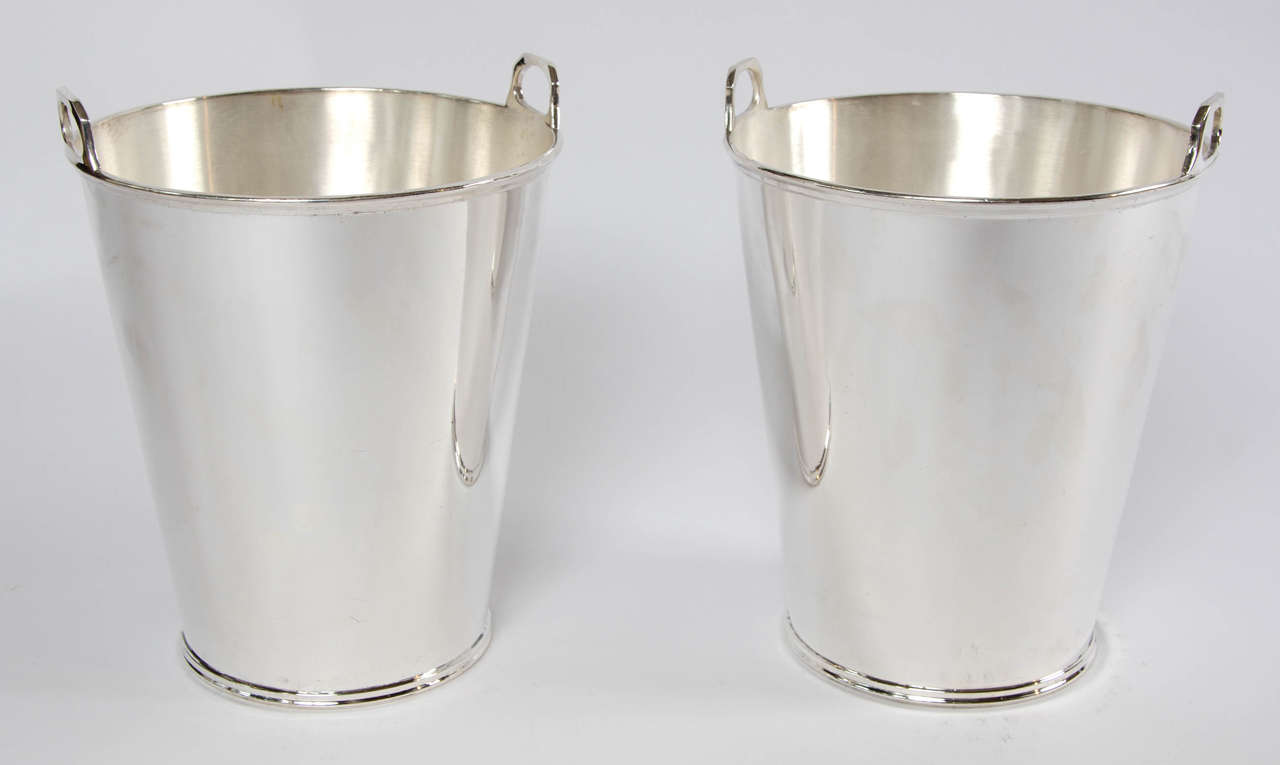 A pair of silver plated Art Deco champagne buckets with raised, integrated handles.