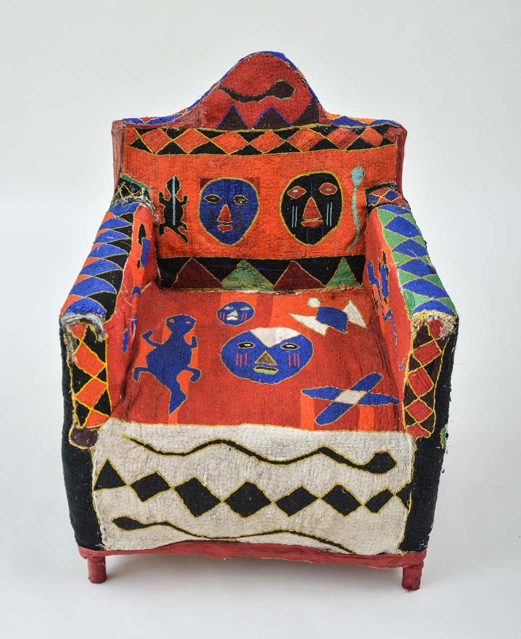 Colorful and intricately hand-beaded chair with iconic tribal, geometric and animal motifs.