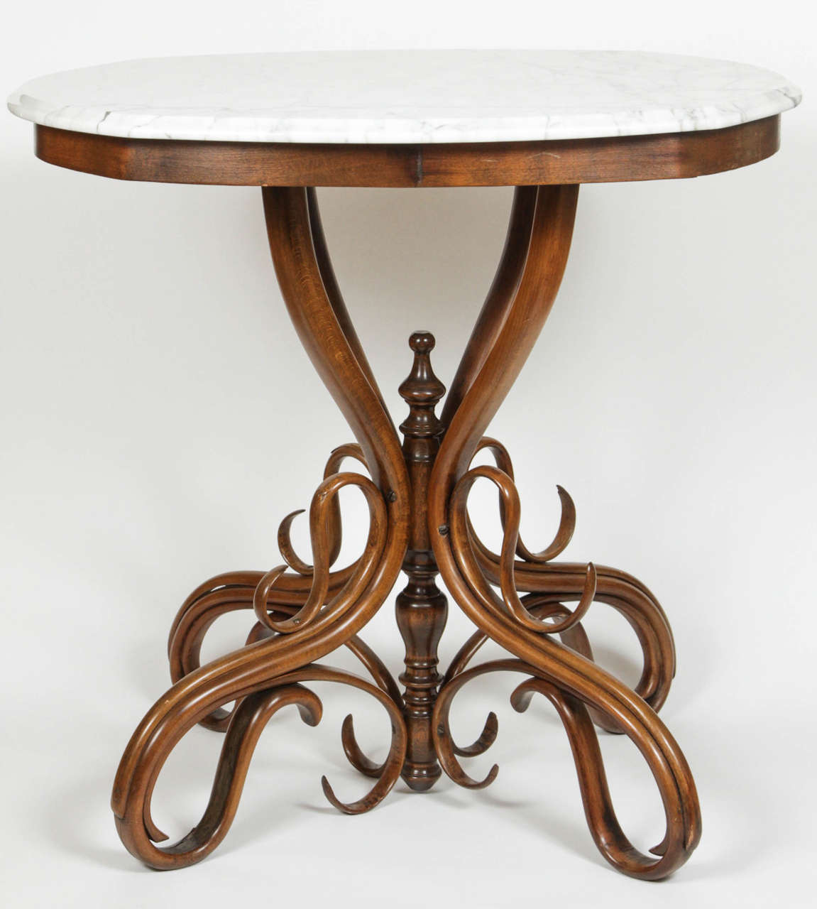 A Thonet bentwood occasional table with marble top, over a bentwood pedestal base with turned standard.
