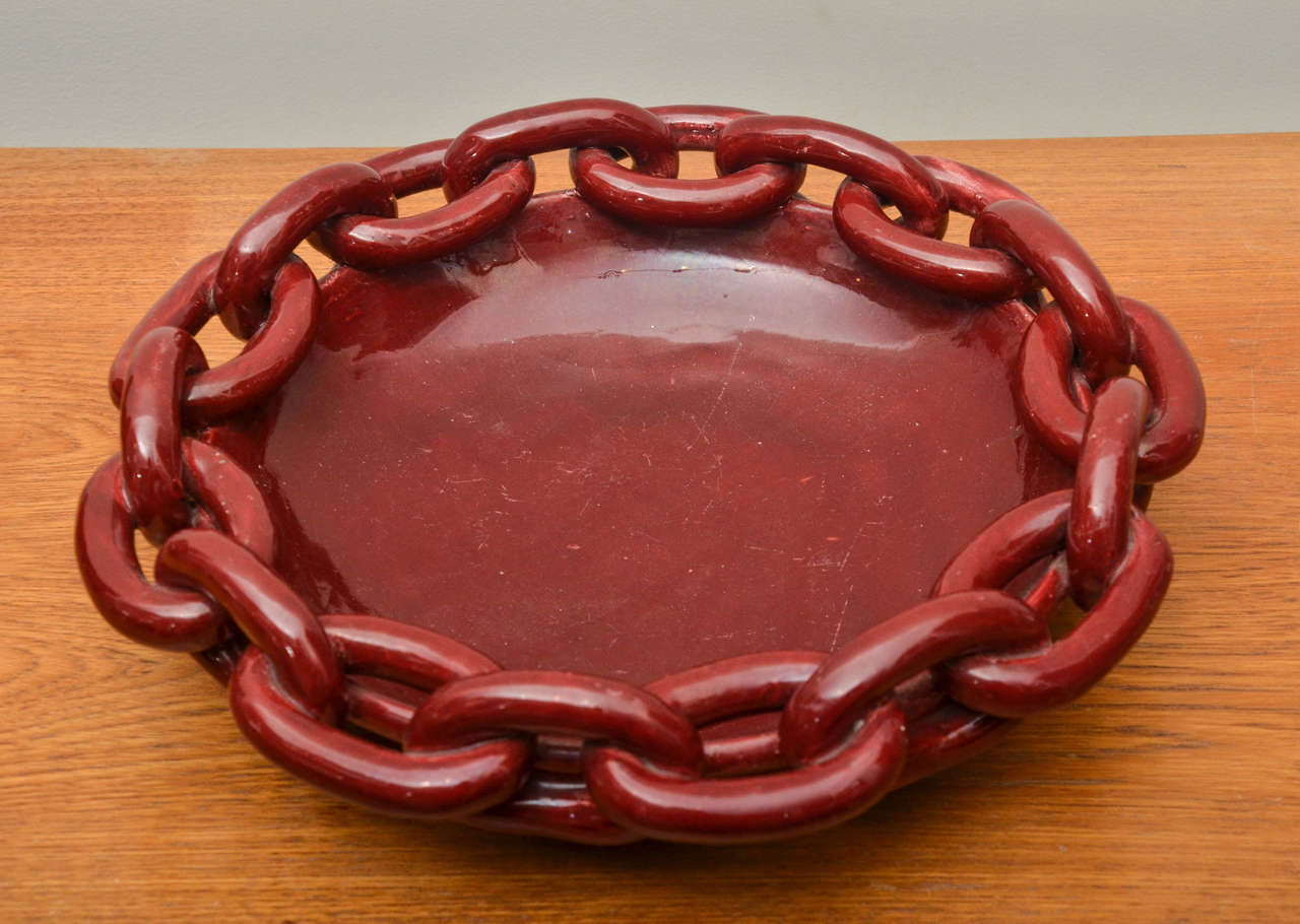Dark red ceramic bowl with linked chain detail
