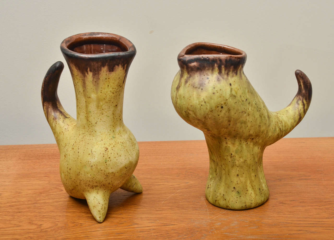 Unique pair of yellow and brown ceramic vessels with artist signature. 
Measurement listed below is for smaller vessel, larger vessel measures: 4