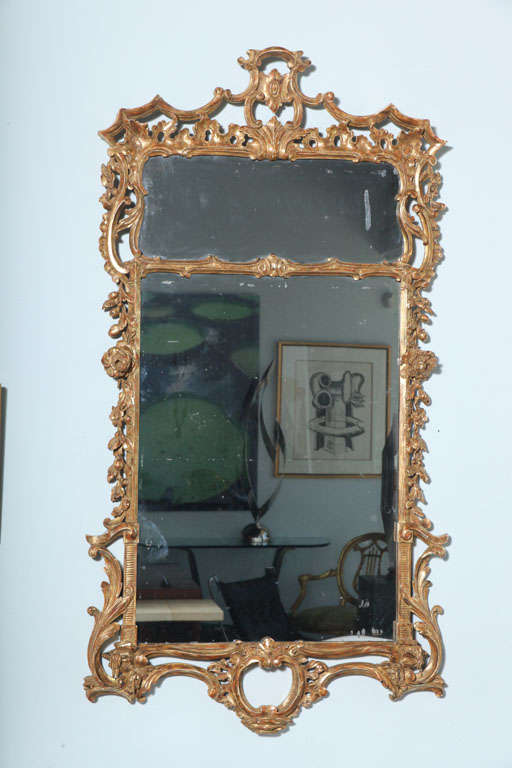 Overall carved with scrolls, rocailles, folaite, flowers with a divided mirror plate, the plates replaced.