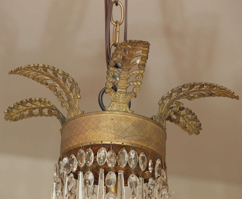 19th Century Bronze and Crystal Empire Chandelier with rare lights inside basket. Circa 1820. Restored and US wired
