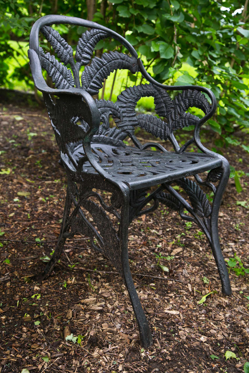 A fine set of cast-iron seating furniture in the Fern pattern, comprised of a settee marked 