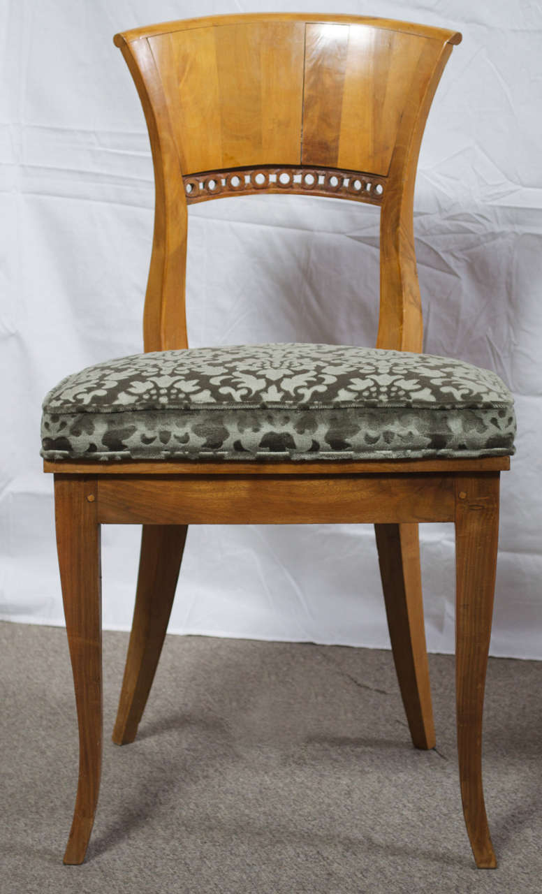 Set of four Biedermeier style fruitwood chairs with original finish and patina. The seats have been recently upholstered in grayish green cut silk velvet that blends well with a variety of color schemes. These chairs can serve equally well as dining