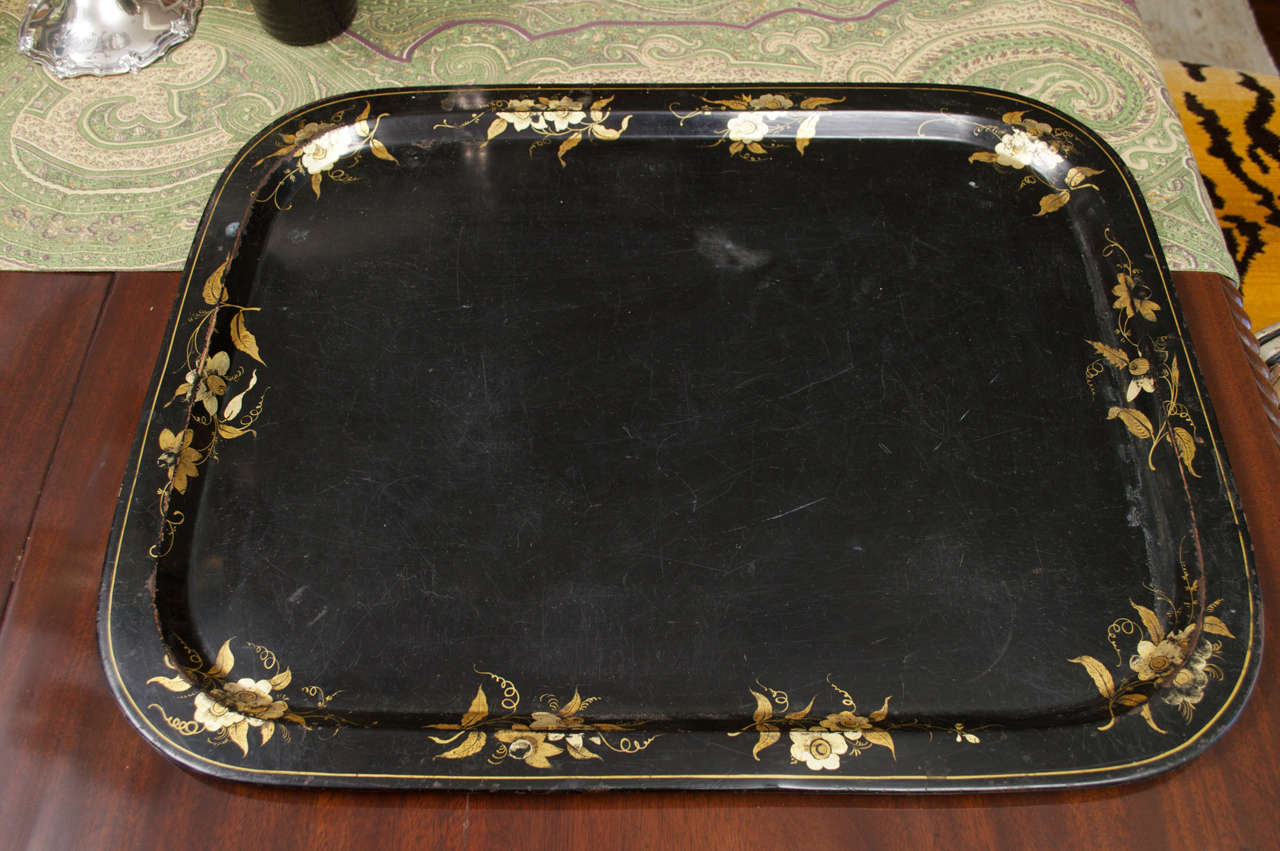The rectangular form with black matte background embellished by gilt buttercups and foliage border.