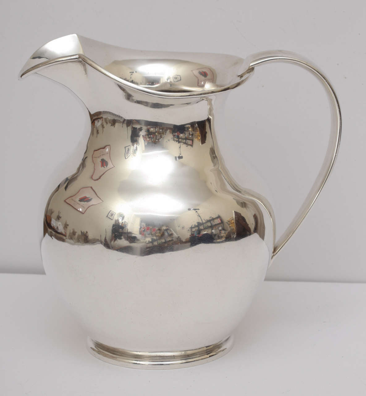 A sterling silver water pitcher by silversmith Edmond Johnson of Dublin, Ireland, one of Dublin's foremost silversmiths. This is a hand wrought piece with a very heavy weight and a nice thick gauge. Made at at the turn of the century, this piece has