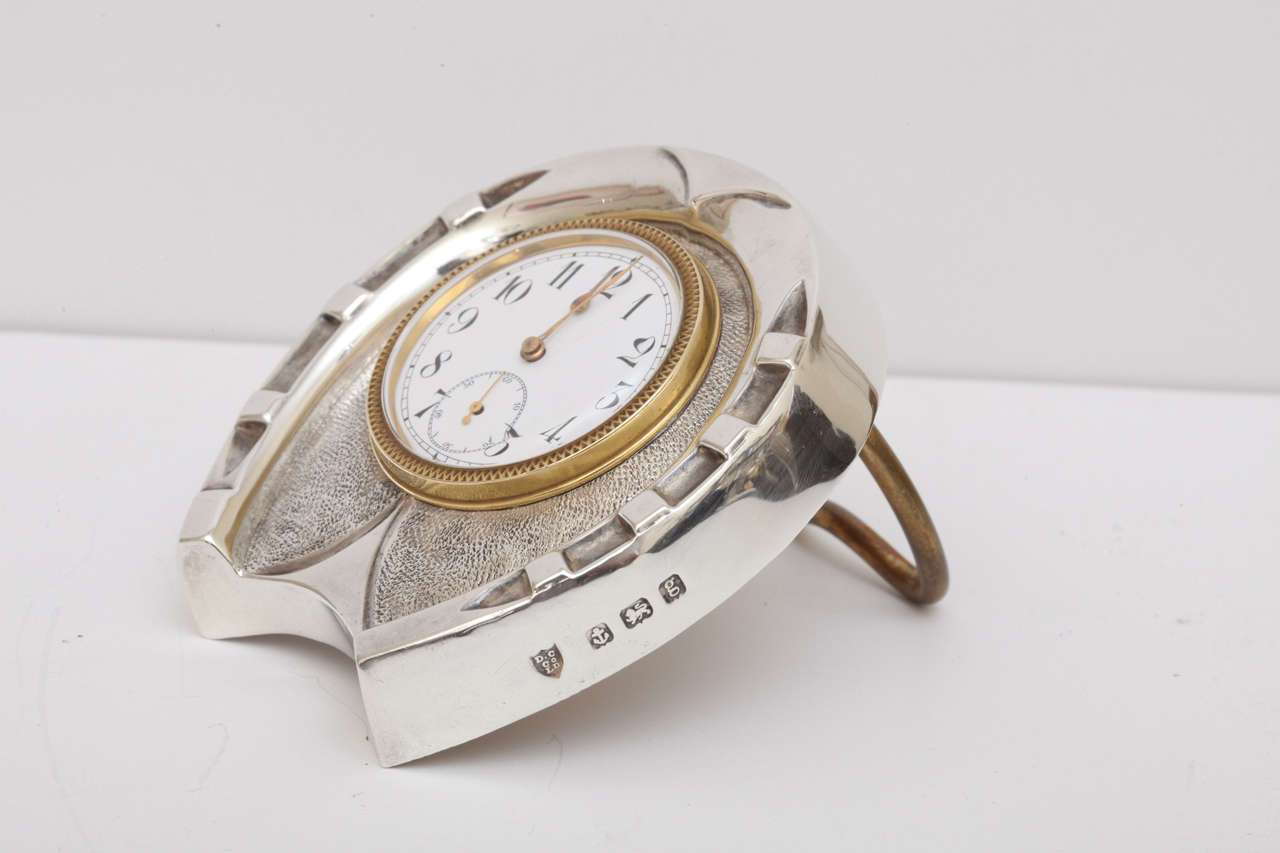 A charming sterling silver horseshoe shaped clock by Douglas Clock Co. Beautifully engraved and detailed with a vermeil millegrain bezel and vermeil hands. Lovely enamel dial features Arabic numerals with a subsidiary seconds dial.  Swiss made