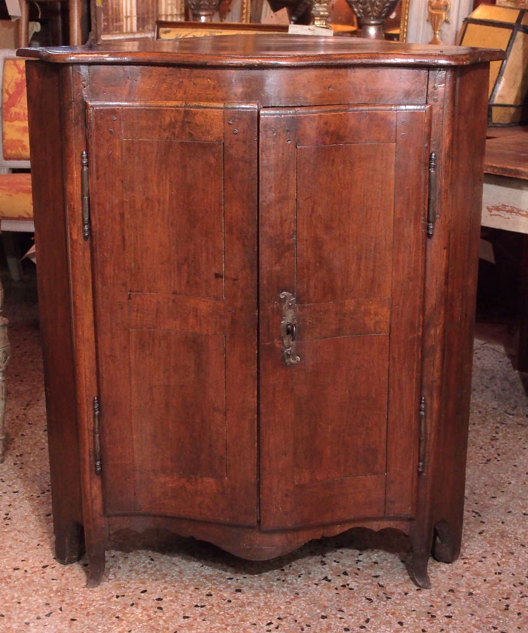 Late 18th century French mahogany corner cabinet.  Molded top over bombe shaped 2 panel doors, 2 interior shelves.