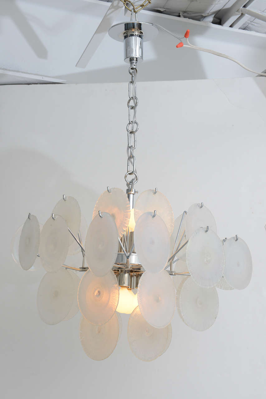 Nicely scaled for bedroom, bath, or entryway - the Murano glass discs on this Vistosi chandelier appear frosty white, but shimmer with iridescent pinks, blues and greens when the light hits it at the right angle. Enchanting and girly!