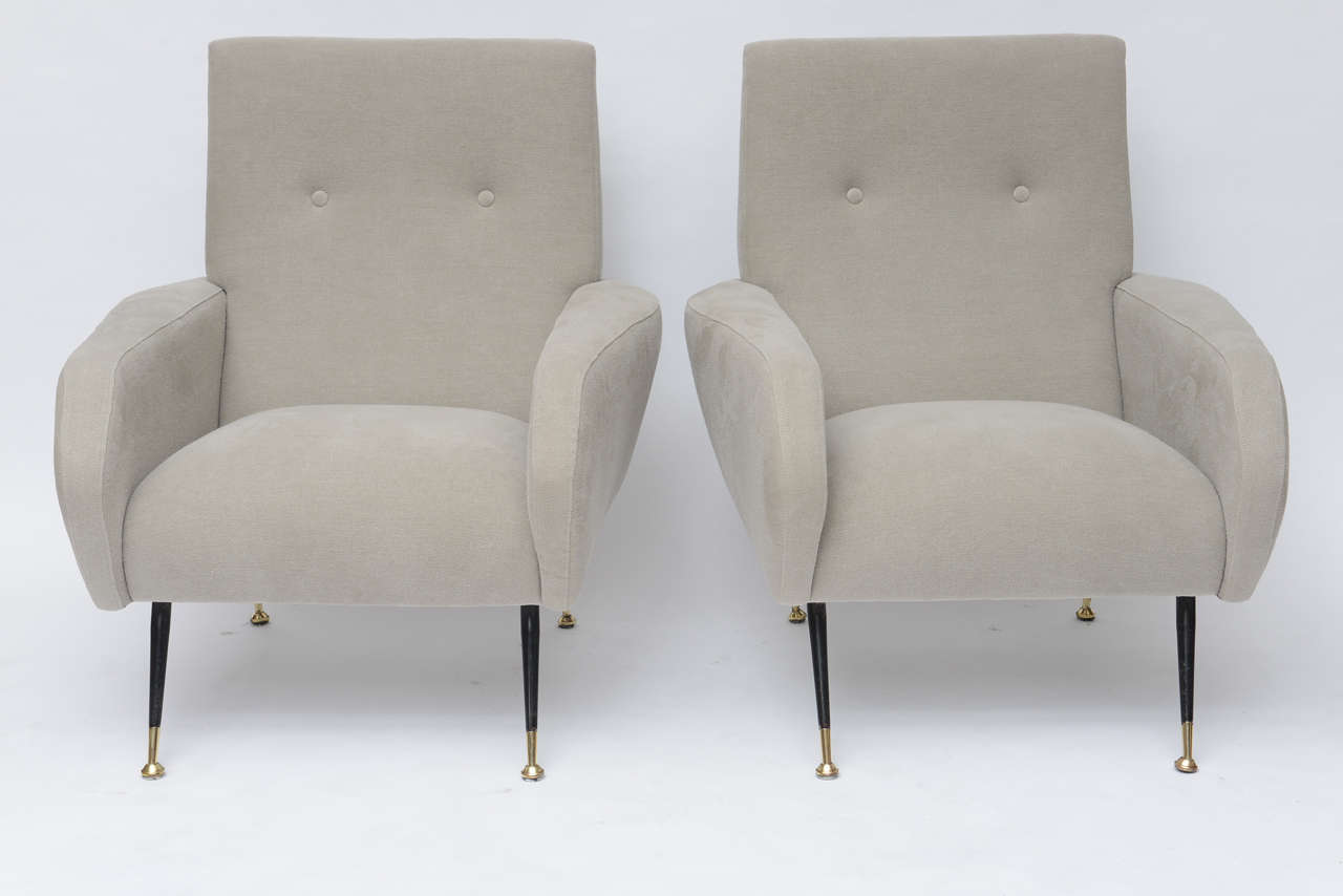 Handsome 50's Italian lounge chairs with black metal legs and polished brass feet. Beautifully upholstered in a thick, pale, oyster-grey, Belgian linen.