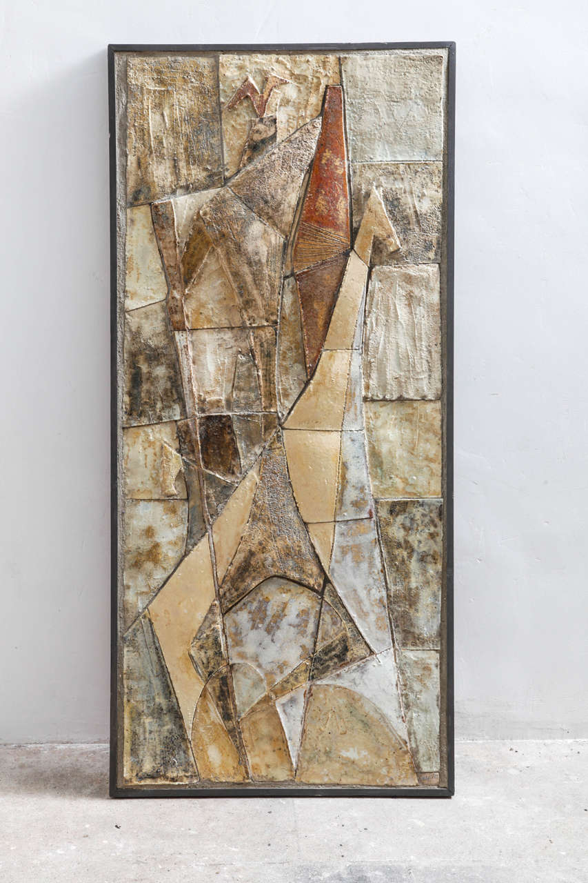 A modernist wall sculpture composed of hand thrown glazed tiles in a variety of shades of brown and white accents in a array of square and rectangular shapes and sizes,produced by the Belgian pottery company Amphora and was designed by Paul Goris