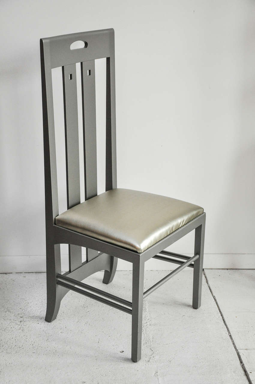 Set of eight Cassina by Charles Mackintosh dining chairs. Reupholstered and recushioned and also repainted in a new metallic lacquer. Head chairs are truly a statement standing tall at 59.25