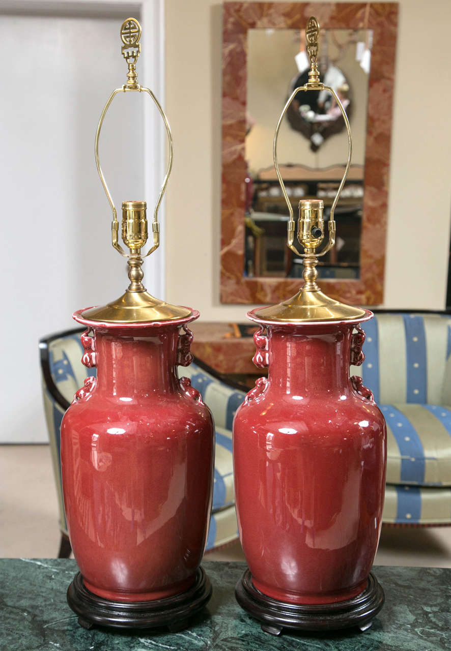 Pair Cinnabar Red Ginger Jar Table Lamps.  A great pair of Cinnabar Red Ginger Jar Table Lamps with black bases and brass top. Lovely color and decorative brass top.  The 19th century used ginger jars as fashionable products creating lamps and