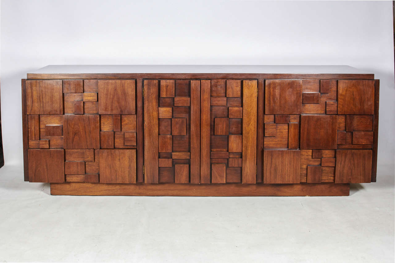 Striking, sculptural nine-drawer dresser. A pair of centre doors open to reveal three drawers. It is an example from the Brutalist Mosaic design series by Lane. Pair of matching nightstands and highboy dresser are also available. Please contact for