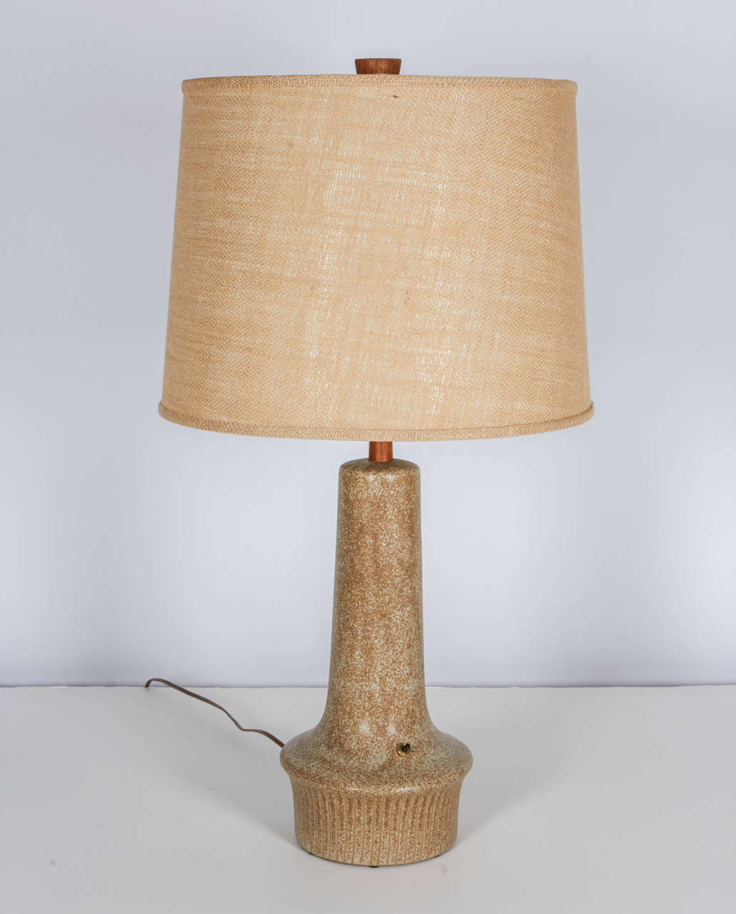 Very handsome pair of studio pottery lamps by Jane and Gordon Martz. They have a wonderful form and finish. An unusual feature are the original three way switches at the bases. The lamps are detailed with the Martz signature walnut stems topped with