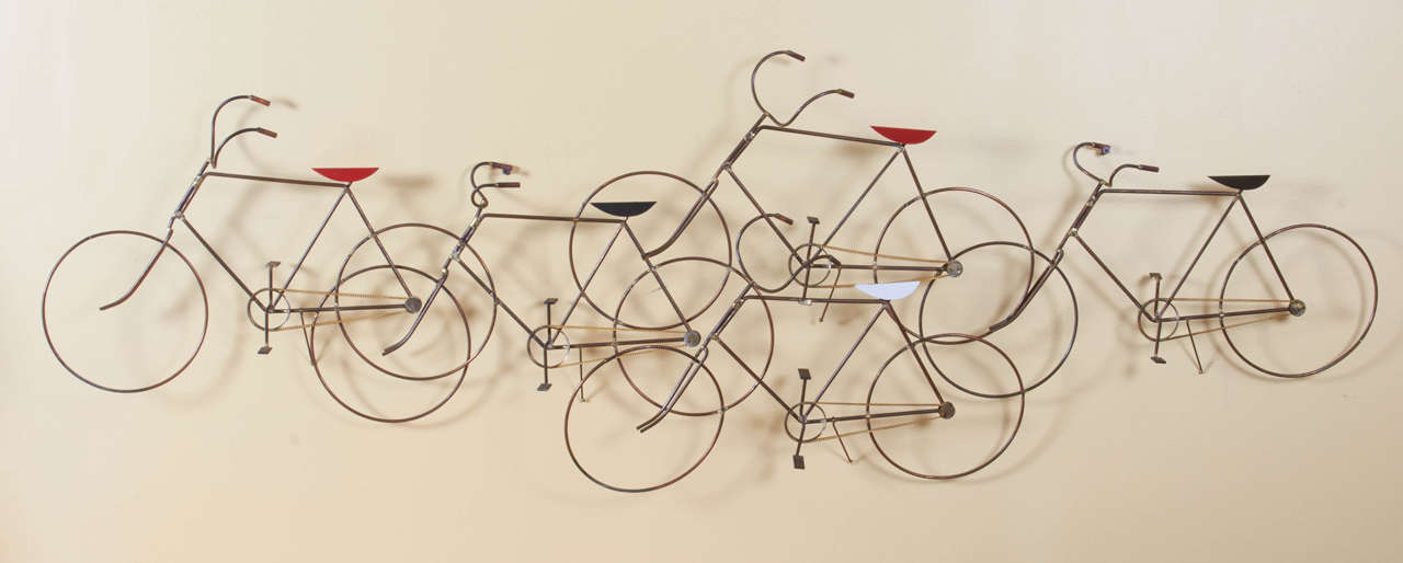 Charming wall sculpture of a group of bicycles designed by Curtis Jere. The sculpture is done in a patinated brass and accented with colorful bicycle seats. Please contact for location.