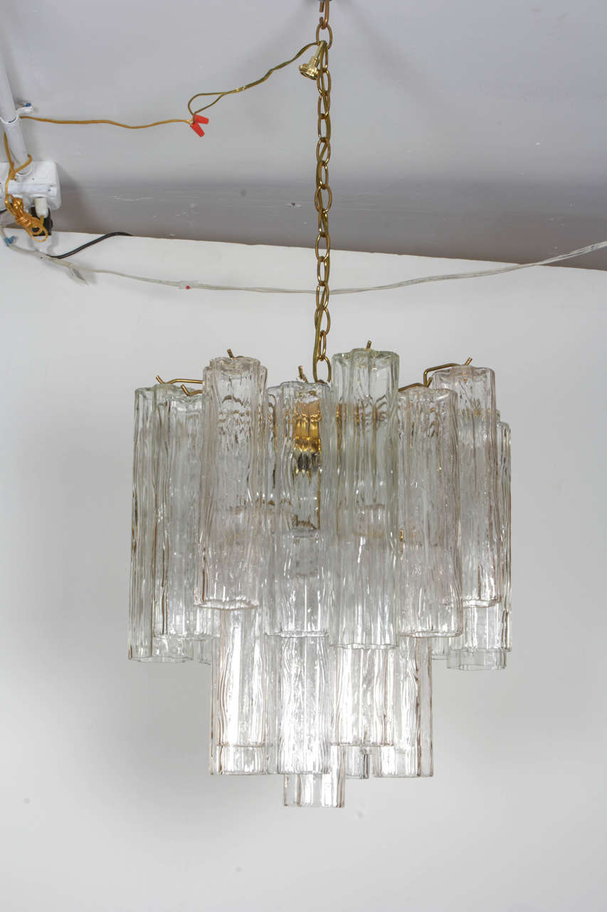 Lovely chandelier with a staggered arrangement of Italian Murano art glass crystals. The chandelier has a chrome armature and is in a versatile scale. Please contact for location. 