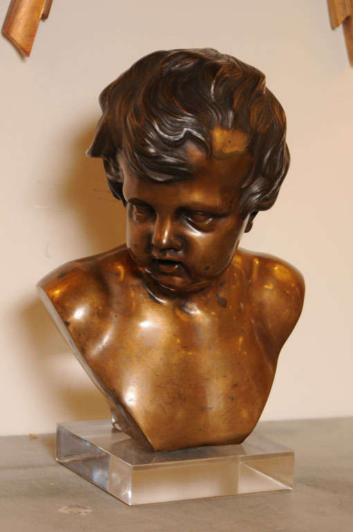Beautiful bronze bust on a later Lucite base, signature stamped Duquesnoy.