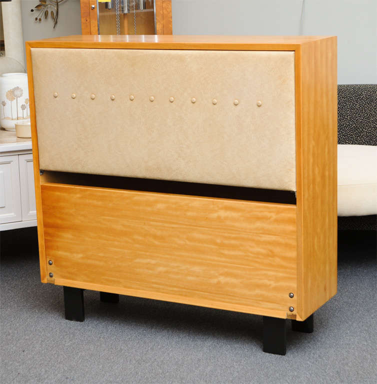 REDUCED FROM $2,150.....Part of the Herman Miller Collection, early 1950s, this headboard by George Nelson is in the sought after Primavera wood. A storage headboard, it's padded back slides down to reveal a shelf and slants to become a headrest and