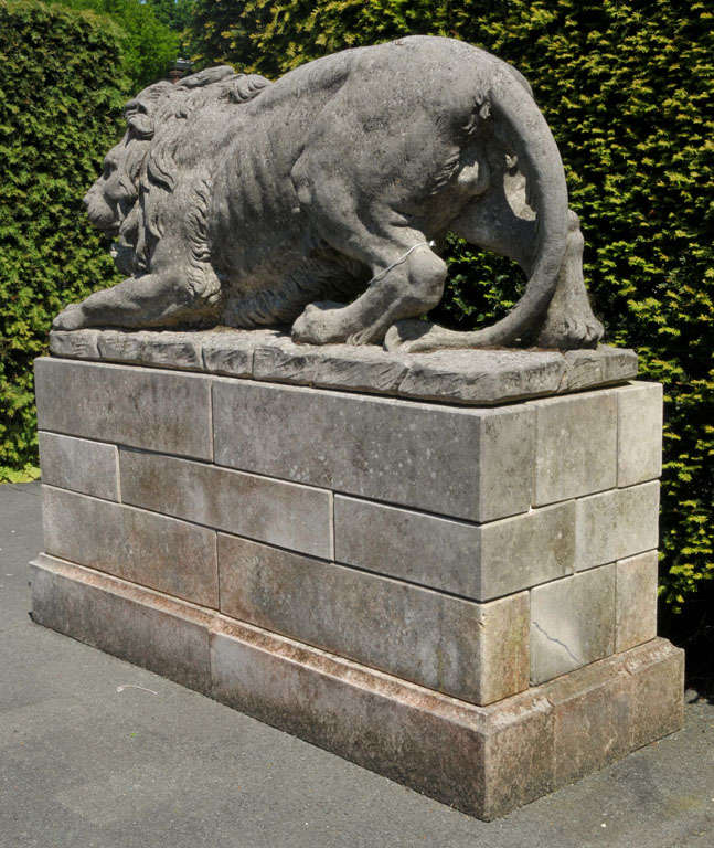 A lareg pair of French sculpted limestone models of lions on plinths 4