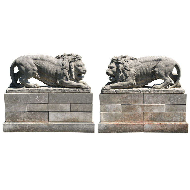 A lareg pair of French sculpted limestone models of lions on plinths