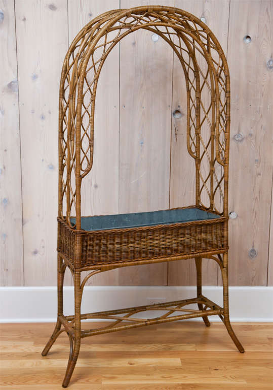 Tall wicker plant stand with tin liner.