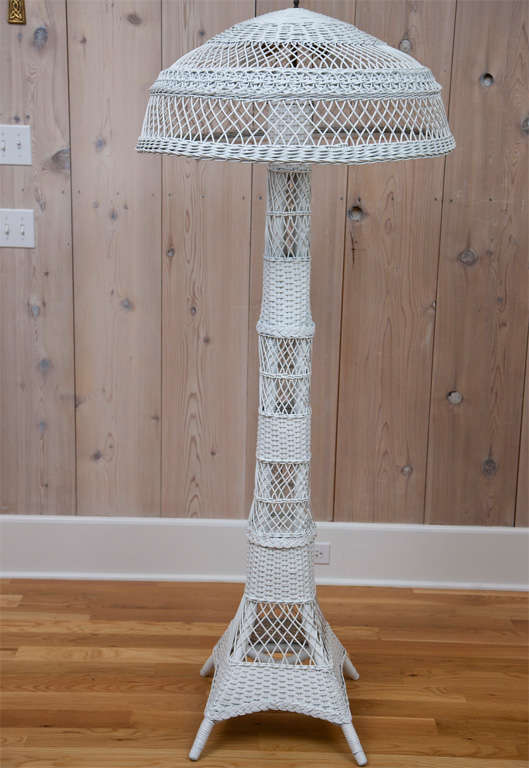 Antique wicker floor lamp with double bulb fixture and pull chains.