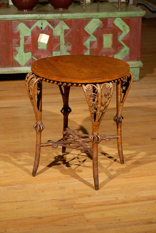 This is a lovely natural wicker table.  It is by Heywood Wakefield.  The table reflects the Victorian styles with the slightly ornate details.  The cabriole legs are a wonderful yet different touch.  This table is a beautiful piece of
