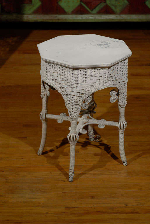 This is a fabulous wicker table.  It is Heywood Wakefield table.  Heywood Wakefield Company started in the late 19th Century combining two prominent wicker and rattan companies.  This taboret has beautiful Victorian details.  It is a charming piece