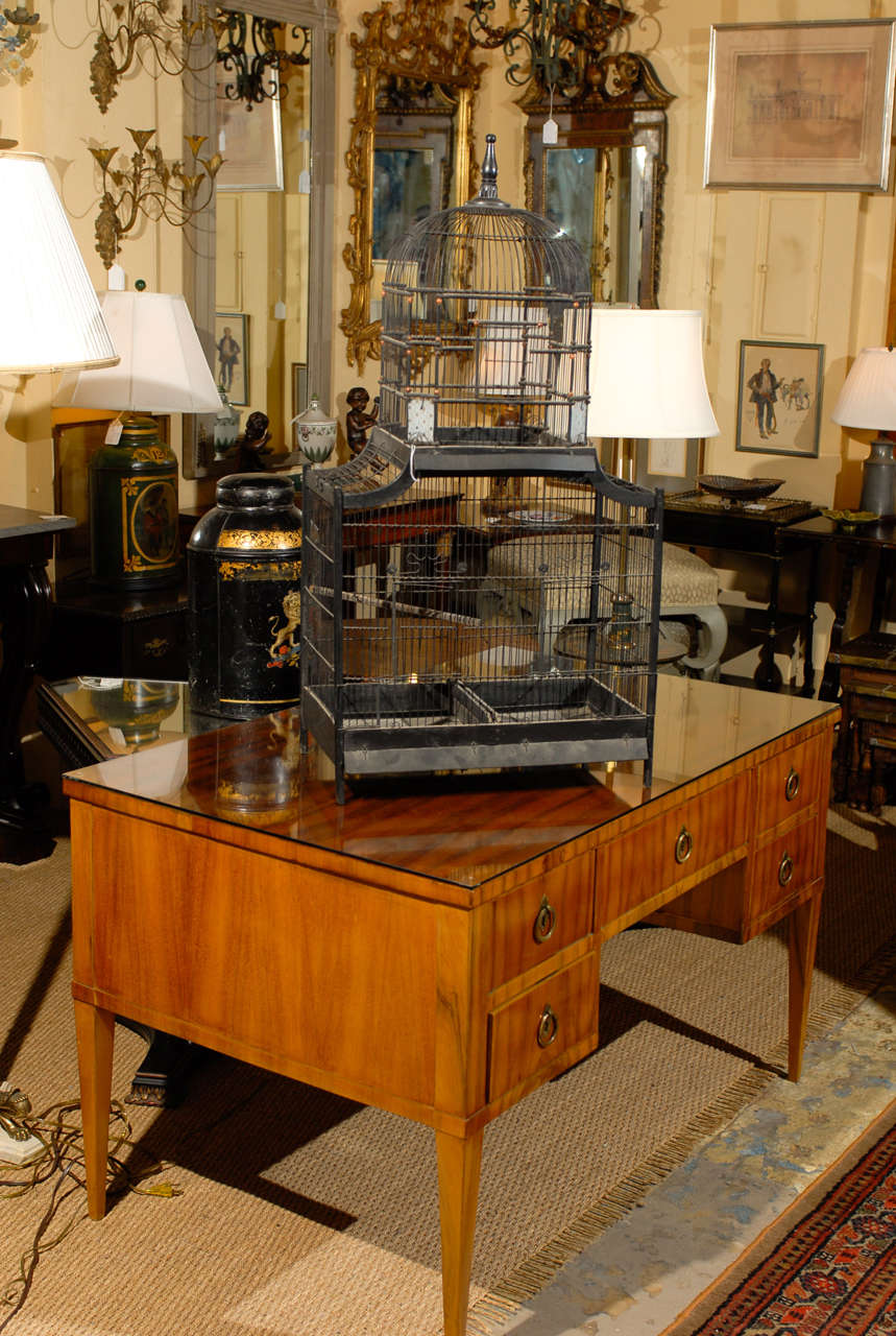 Antique bird cage of painted wood, metal, and decorative etched glass ornaments and beads.