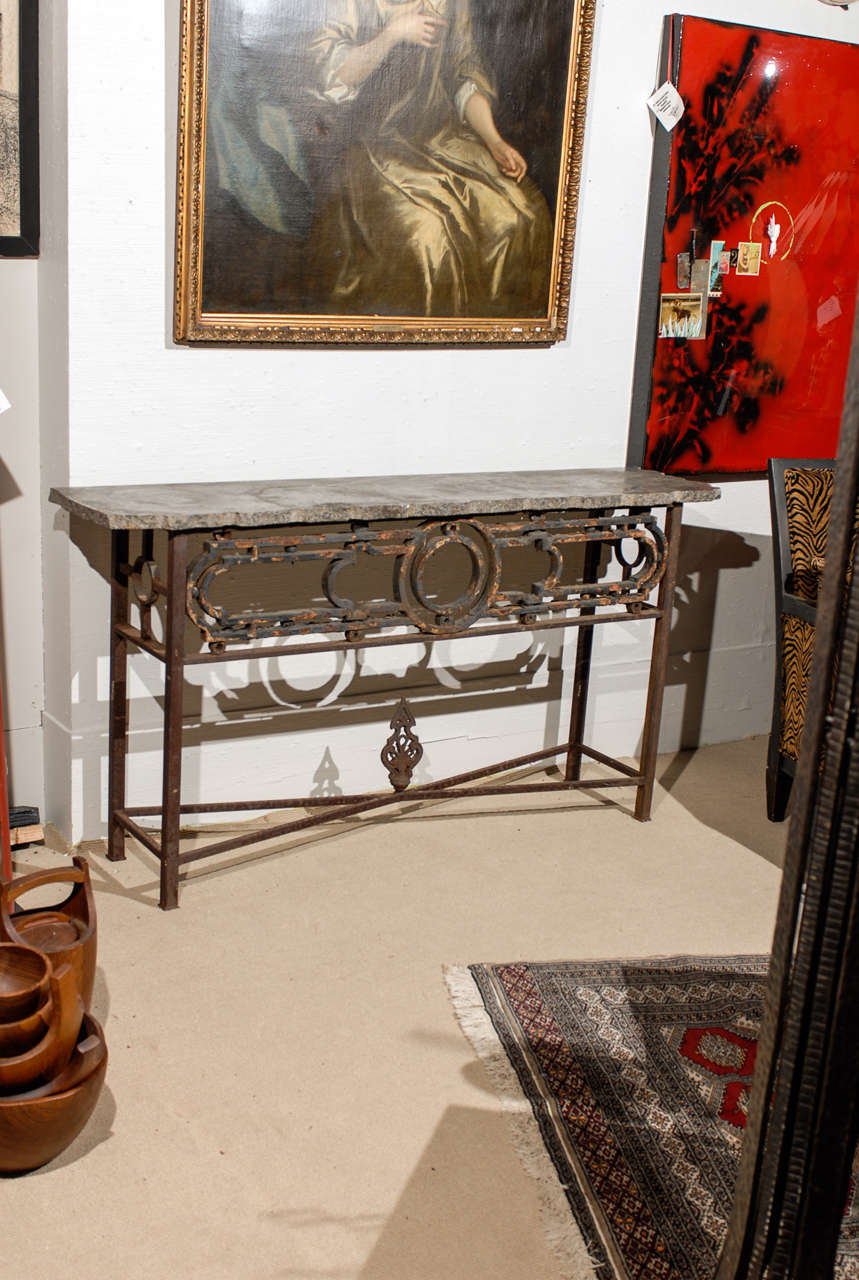 Art Deco Period iron fragments made into a console table with a grey granite top having a rough hewn edge.
