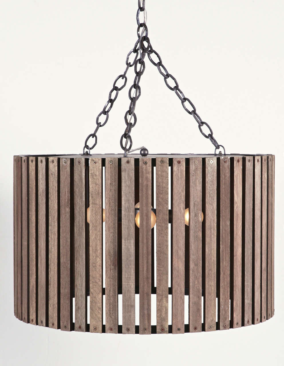 Four-light drum pendants
Distress wood slat in age brown finish
Perforated matte black iron diffuser sits at the top, creating pinpoint shadows on the ceiling. 

Four bulbs/ 25 wattage 
includes canopy and chain 

Sold separately.
 