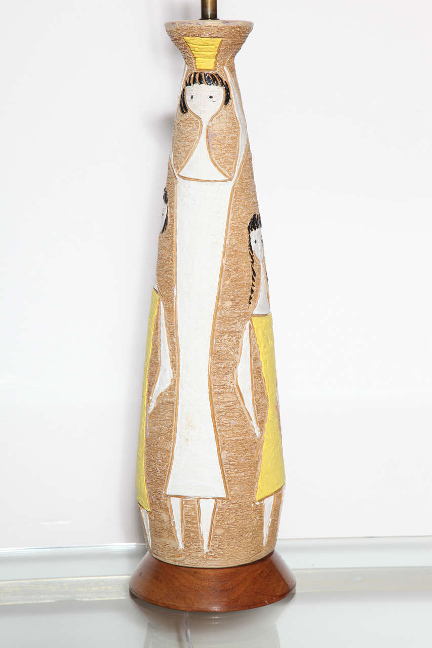 Monumental Frederick Weinberg handcrafted Fine Art In Plaster Table Lamp. Featuring a tall, elongated bottle form in textured hydrocal with tan, camel background, incised and decorated with four dark haired female figures in yellow and white