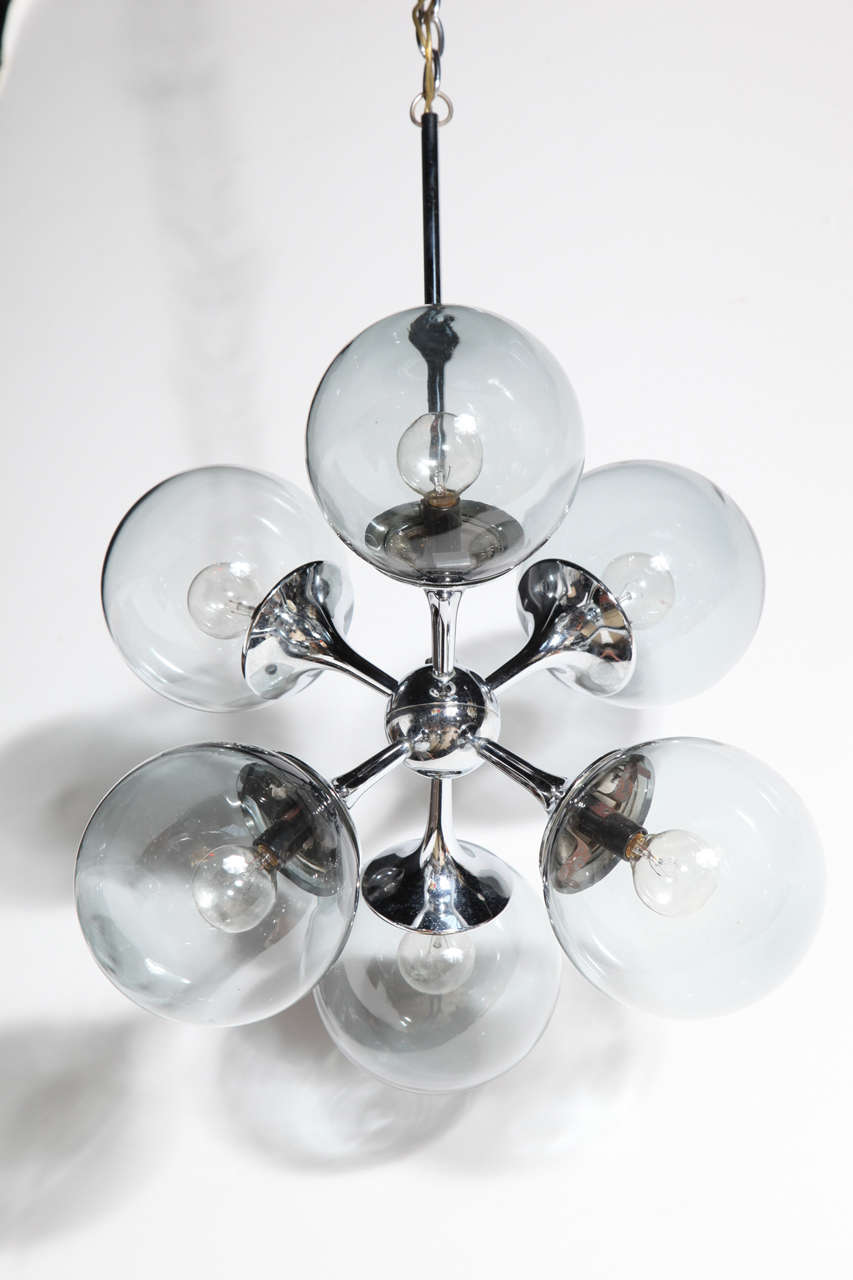 circa 1960's small Lightolier Sputnik Chandelier complete with 6 polished Chrome trumpet arms fitted with original 6 Smoked Glass Globe spheres.  Chrome is in fine condition (without pitting). The 6 smoked glass spheres are 
5