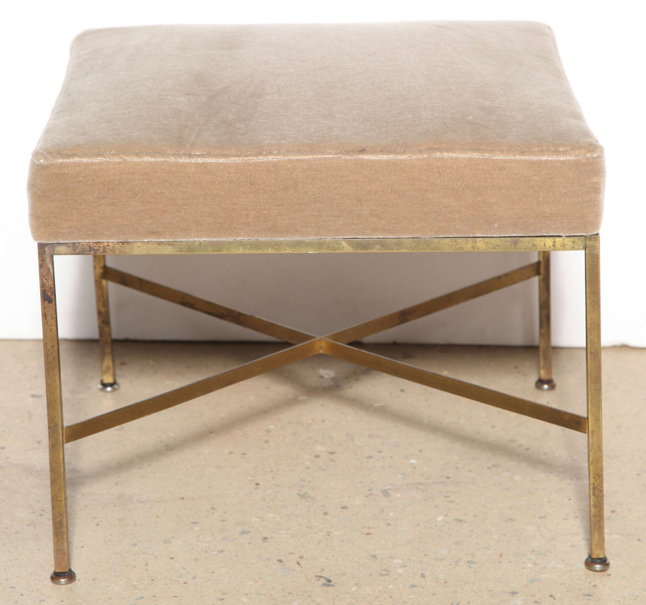 circa 1950 single, square x base Brass Ottoman by Paul McCobb for Directional.  Functional lightweight Stools.  Newly upholstered in Taupe Velvet

*COSMO SUMMER HOURS* 
open Monday-Thursday 12pm-5pm
open Friday-Sunday by chance or prior