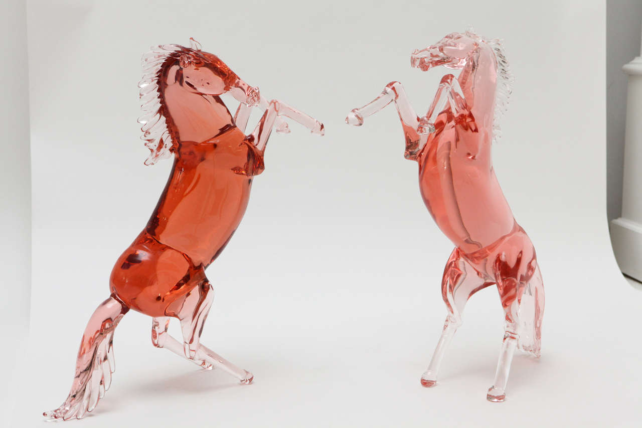 A striking pair of pink Murano glass rearing stallions by master glass artist, Pino Signoretto. Both horses bear his signature on their inside back leg.
